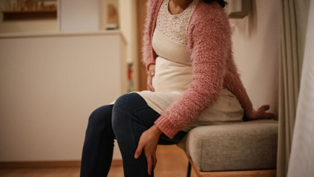 A pregnant woman experiencing burning sensation