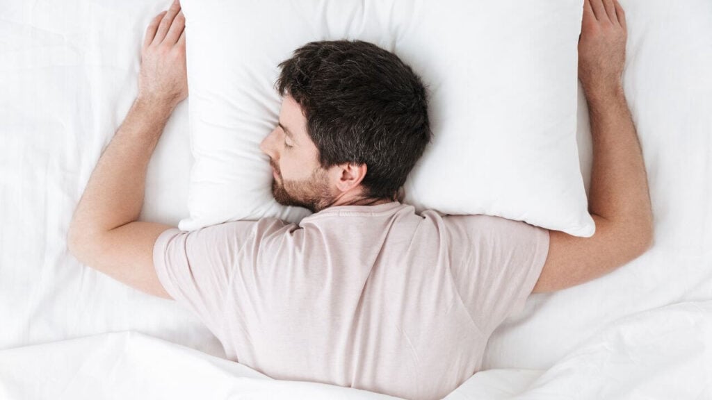 A man sleeps on his stomach